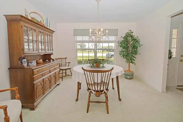 a dining room with furniture window and wooden floor