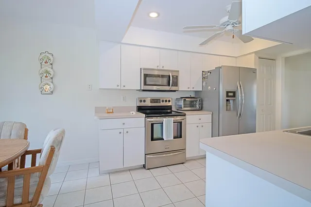 a kitchen with cabinets and stainless steel appliances