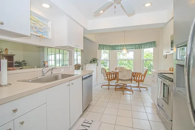 a spacious bathroom with a granite countertop sink a mirror and a shower