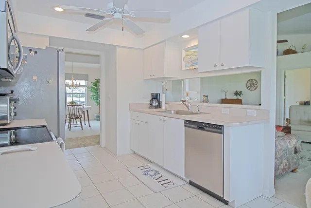 a kitchen with a sink cabinets and window