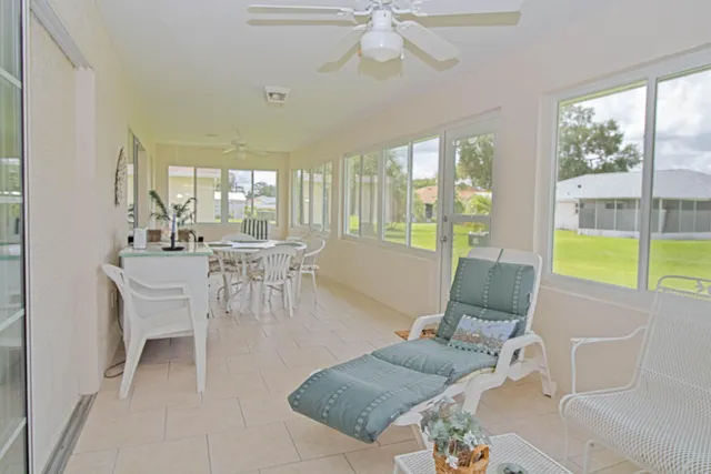 a living room with fireplace furniture and a large window