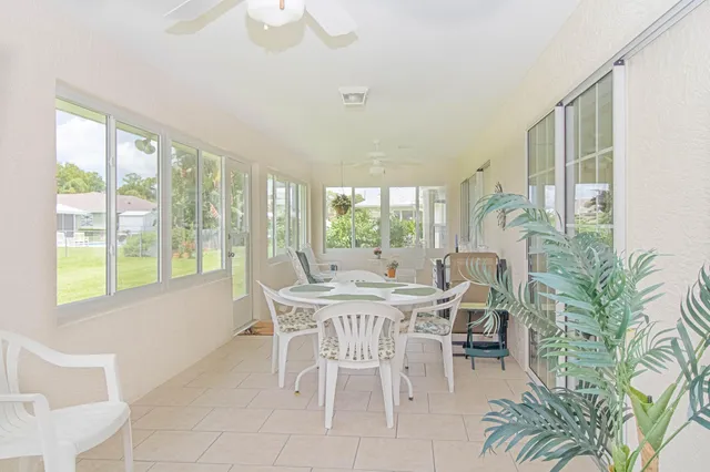 a view of a dining room with furniture window and outside view