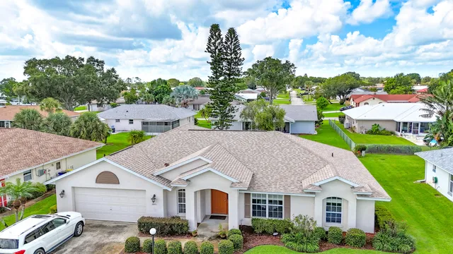 a aerial view of a house next to a yard