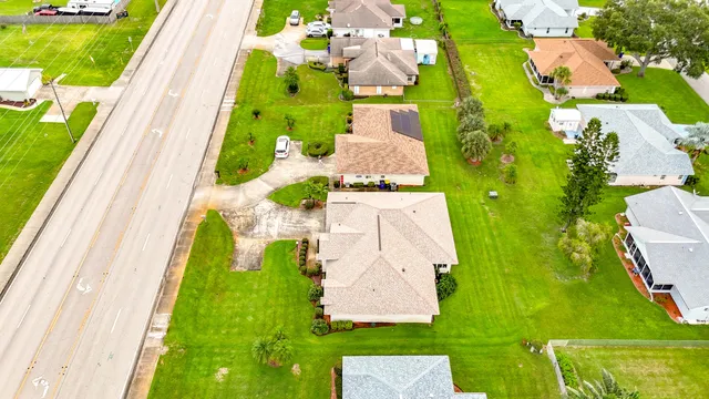 an aerial view of a house with a garden and swimming pool