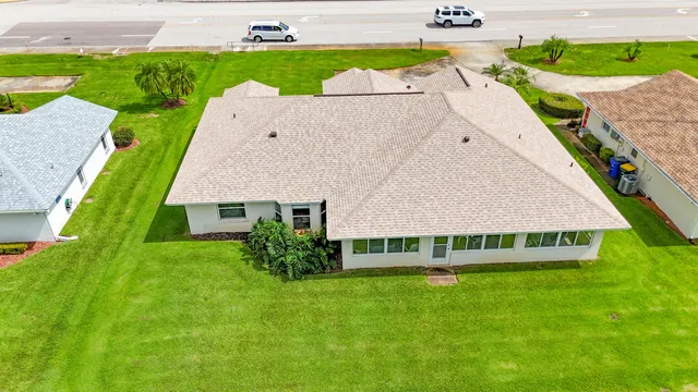 a view of a house with a backyard