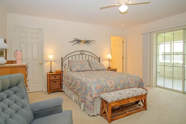 a bedroom with a bed couch and window