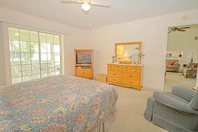a bedroom with a bed and dresser with mirror