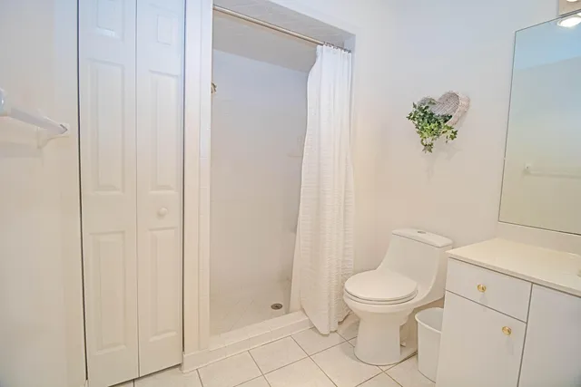 a white toilet sitting next to a bathroom sink
