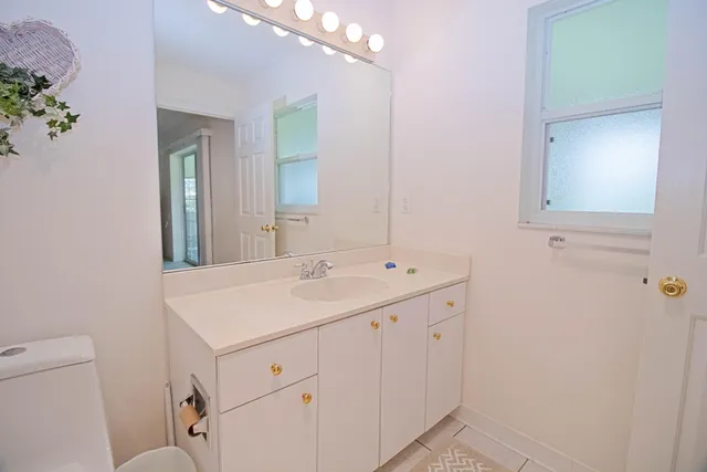 a bathroom with a sink a vanity and a mirror