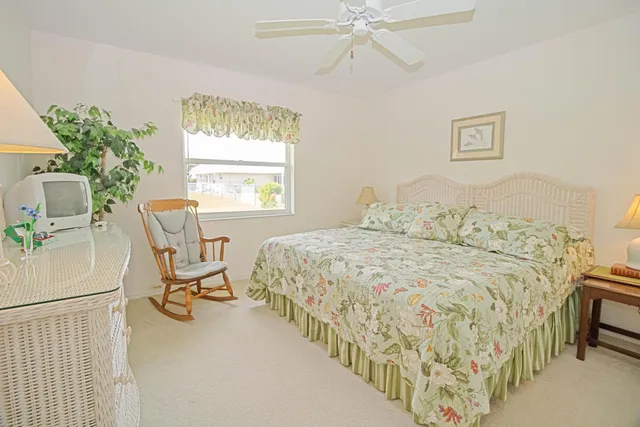 a bedroom with a bed and a chair