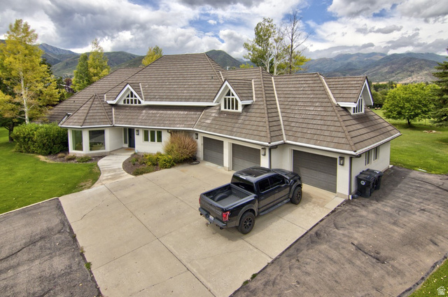 180 Farm Road Midway, UT 84049 - Photo 20 of 99 Expansive residence featuring a multi-gabled roofline, three garage doors, and a concrete driveway