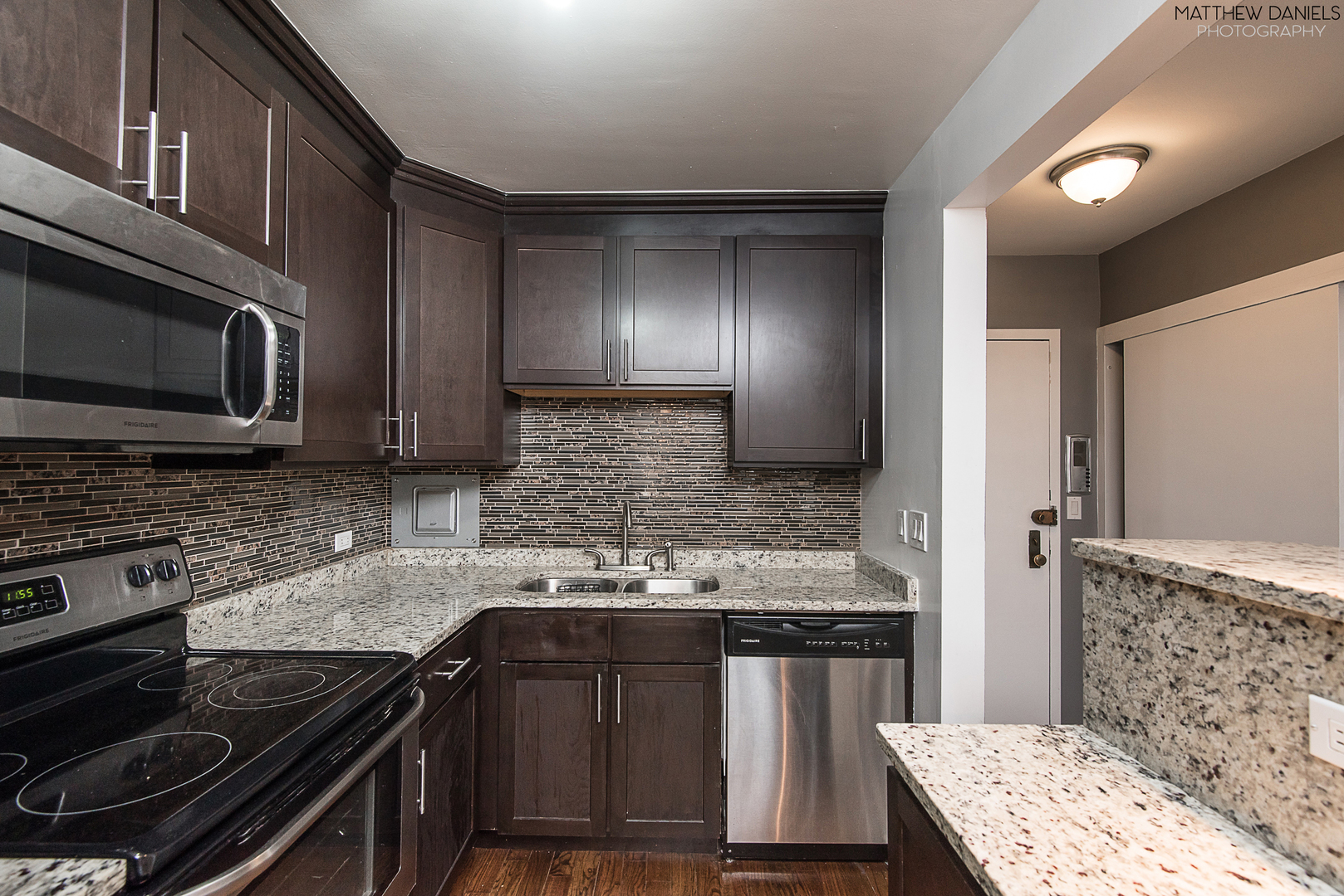 5757 North Sheridan Road, Unit 8C Chicago, IL 60660 - Photo 11 of 15 a kitchen with stainless steel appliances granite countertop a stove and a microwave