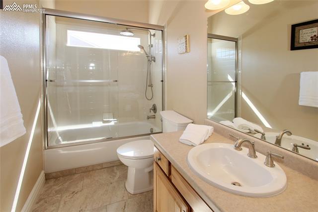 12010 Rio Secco Road Peyton, CO 80831 - Photo 16 of 36 Updated 12" x 24" tile, new luxury shower heads and glass doors