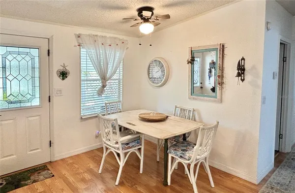 a view of a dining room with furniture and a window