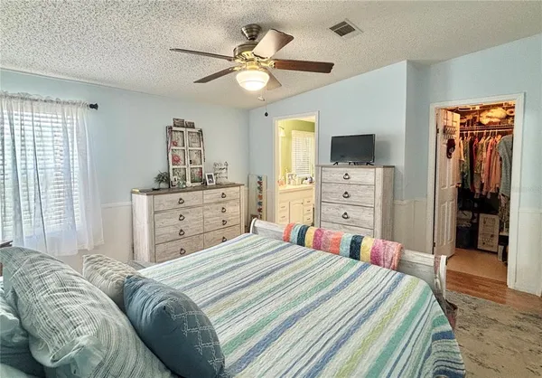 a bedroom with a bed and a chandelier