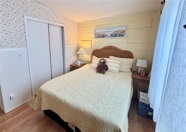 a bedroom with a bed and a mirror