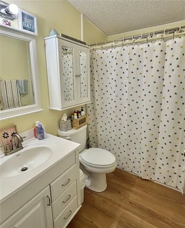 a bathroom with a sink toilet and a mirror