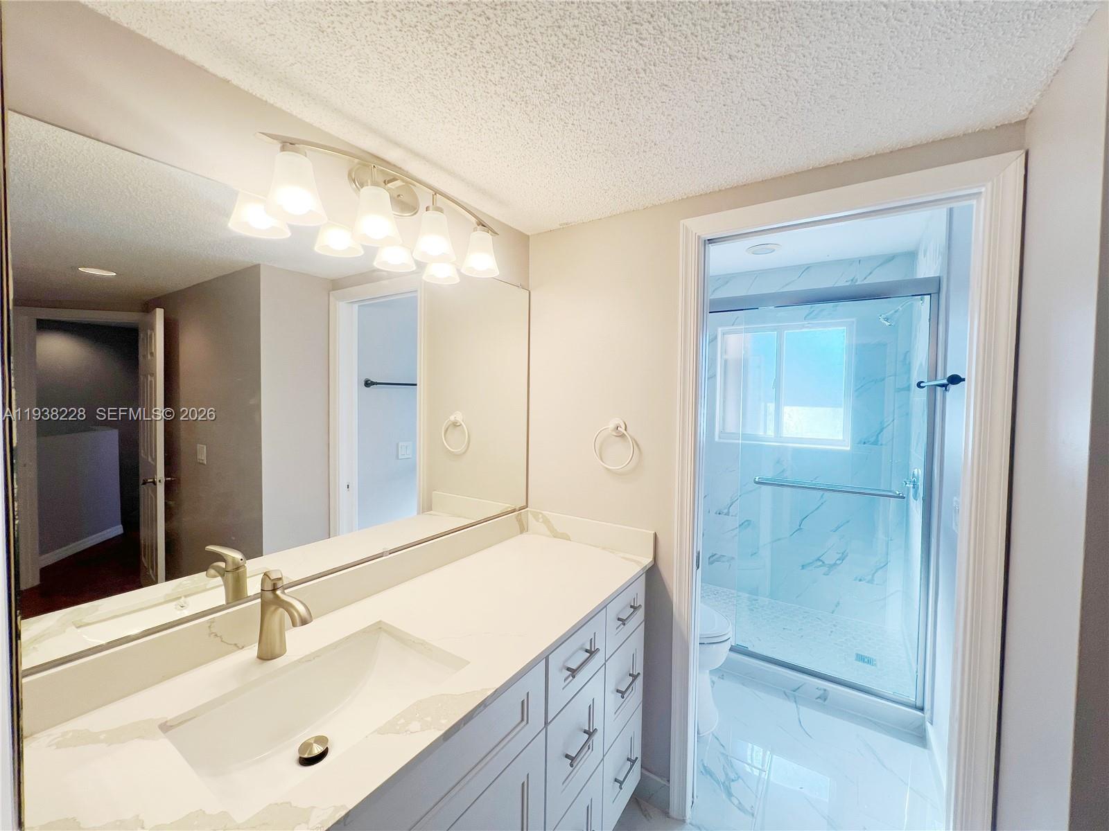 15827 Southwest 12th Street Pembroke Pines, FL 33027 - Photo 14 of 24 a bathroom with a sink and a mirror