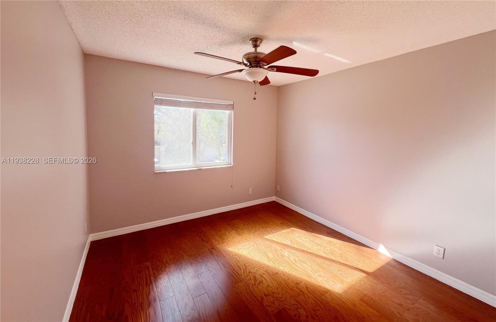 15827 Southwest 12th Street Pembroke Pines, FL 33027 - Photo 17 of 24 an empty room with a window and wooden floor