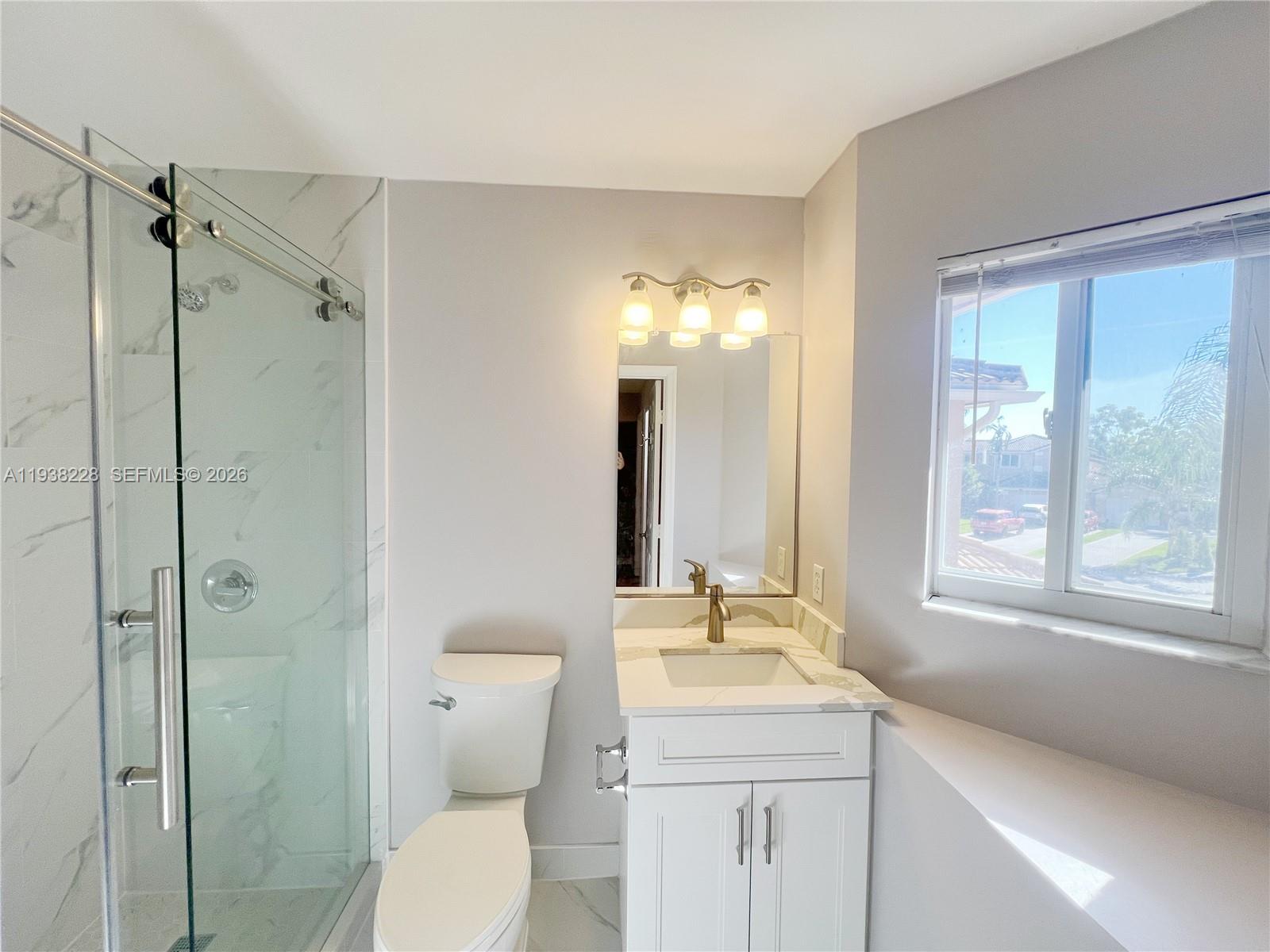 15827 Southwest 12th Street Pembroke Pines, FL 33027 - Photo 20 of 24 a bathroom with a granite countertop sink toilet and shower