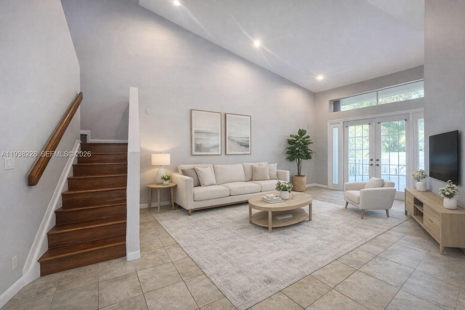 15827 Southwest 12th Street Pembroke Pines, FL 33027 - Photo 2 of 24 a living room with furniture and a flat screen tv