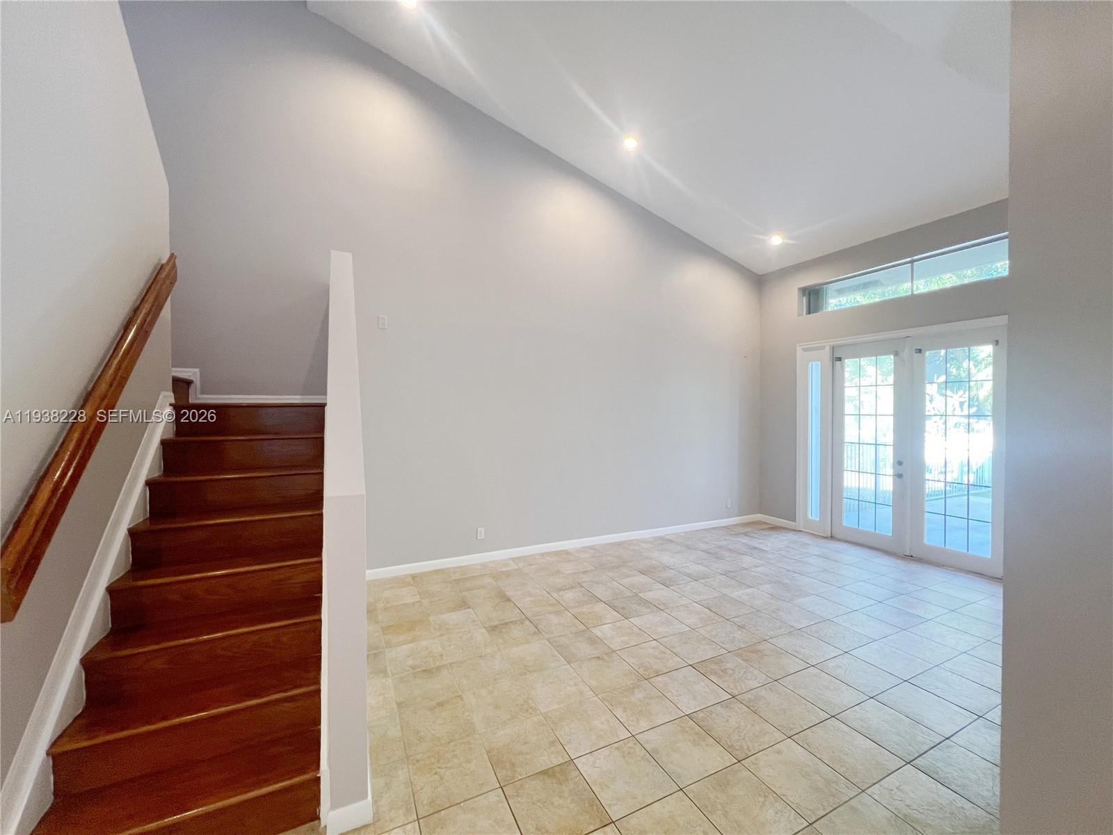 15827 Southwest 12th Street Pembroke Pines, FL 33027 - Photo 3 of 24 a view of an empty room with stairs