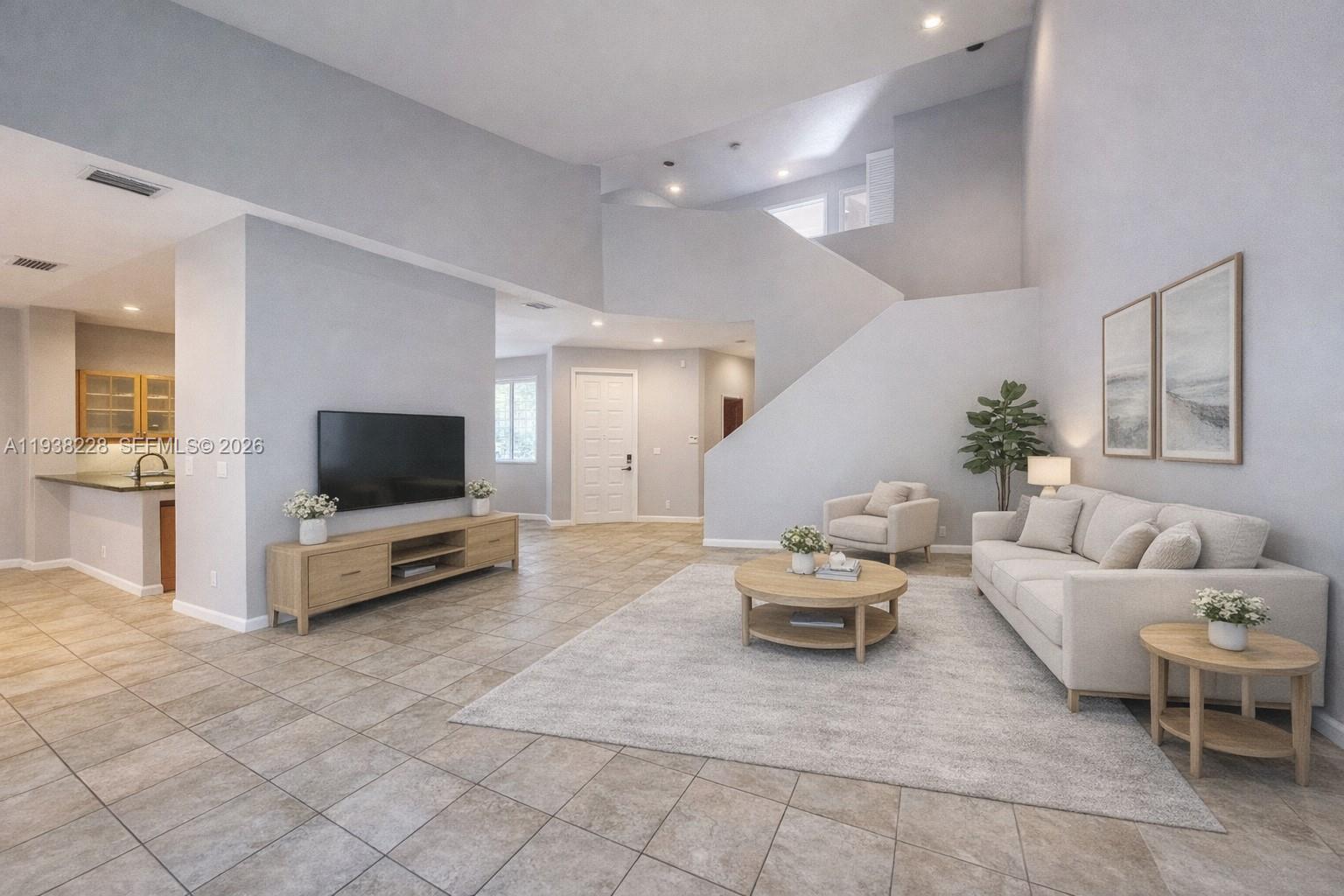 15827 Southwest 12th Street Pembroke Pines, FL 33027 - Photo 4 of 24 a living room with furniture and a flat screen tv