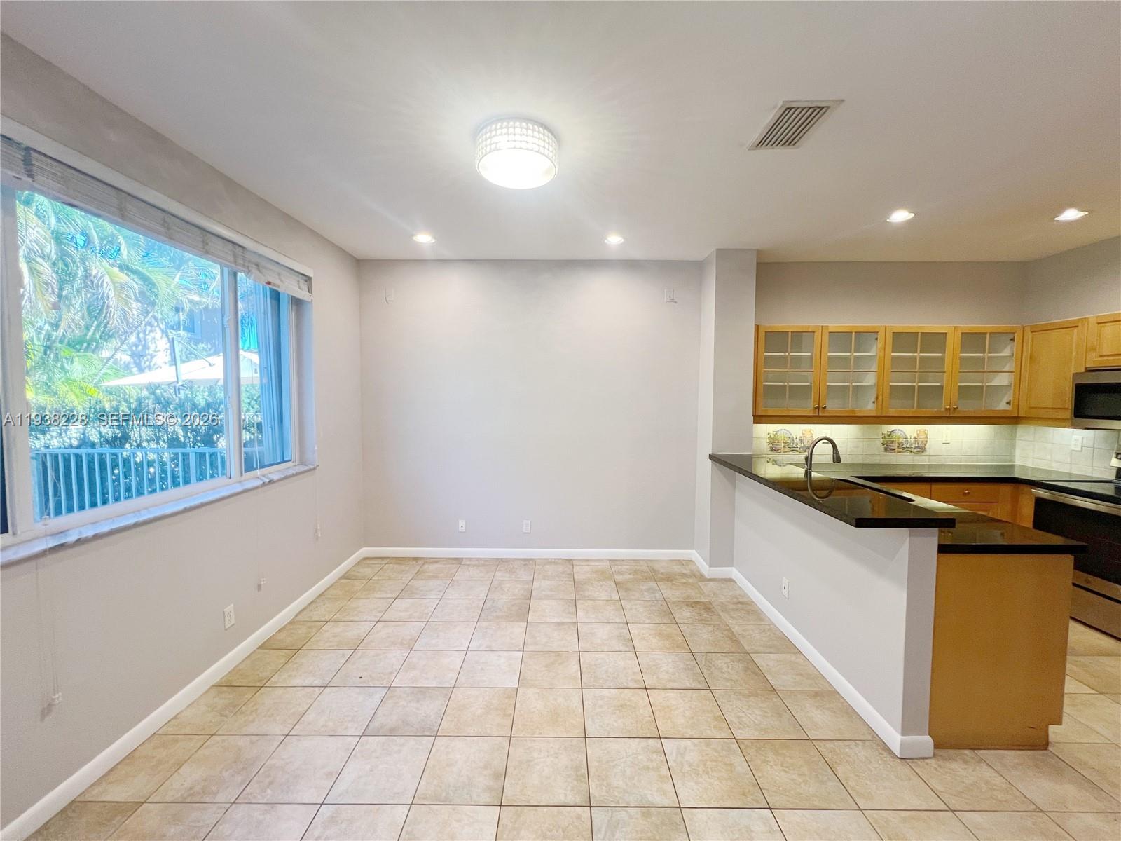 15827 Southwest 12th Street Pembroke Pines, FL 33027 - Photo 7 of 24 a kitchen with granite countertop a sink and a stove