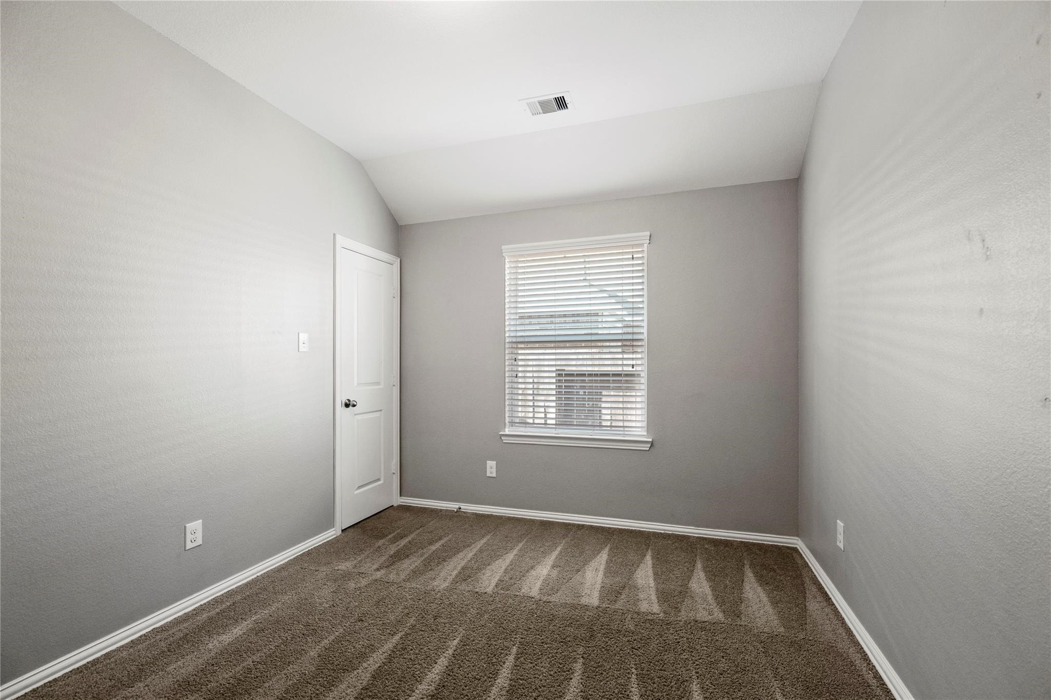 29507 Whitebrush Trace Drive Spring, TX 77386 - Photo 9 of 32 Secondary bedroom with window and wood-look flooring.