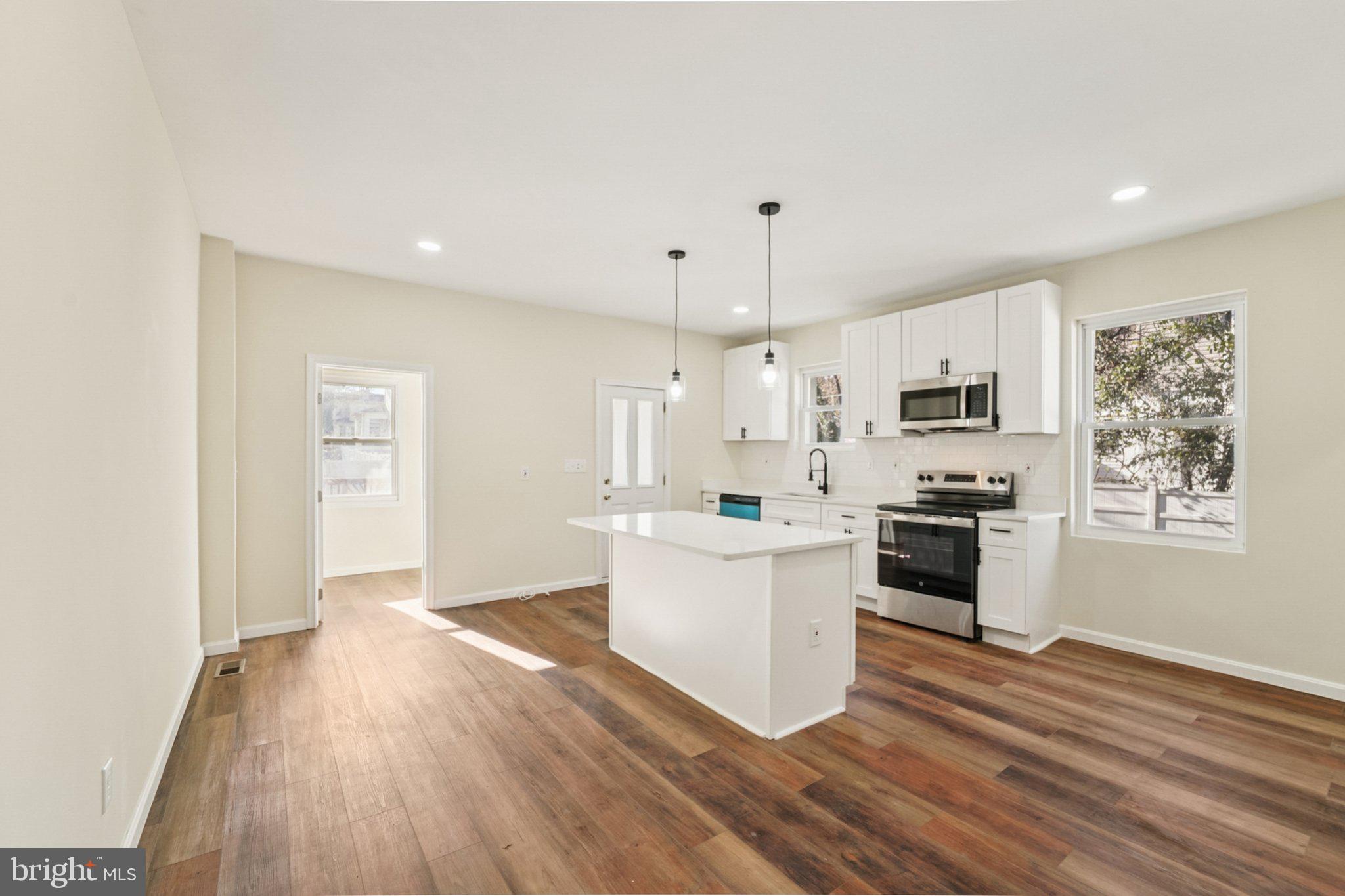 3603 Springdale Avenue Baltimore, MD 21216 - Photo 15 of 63 a kitchen with white cabinets and appliances