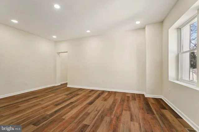 an empty room with a empty space and windows