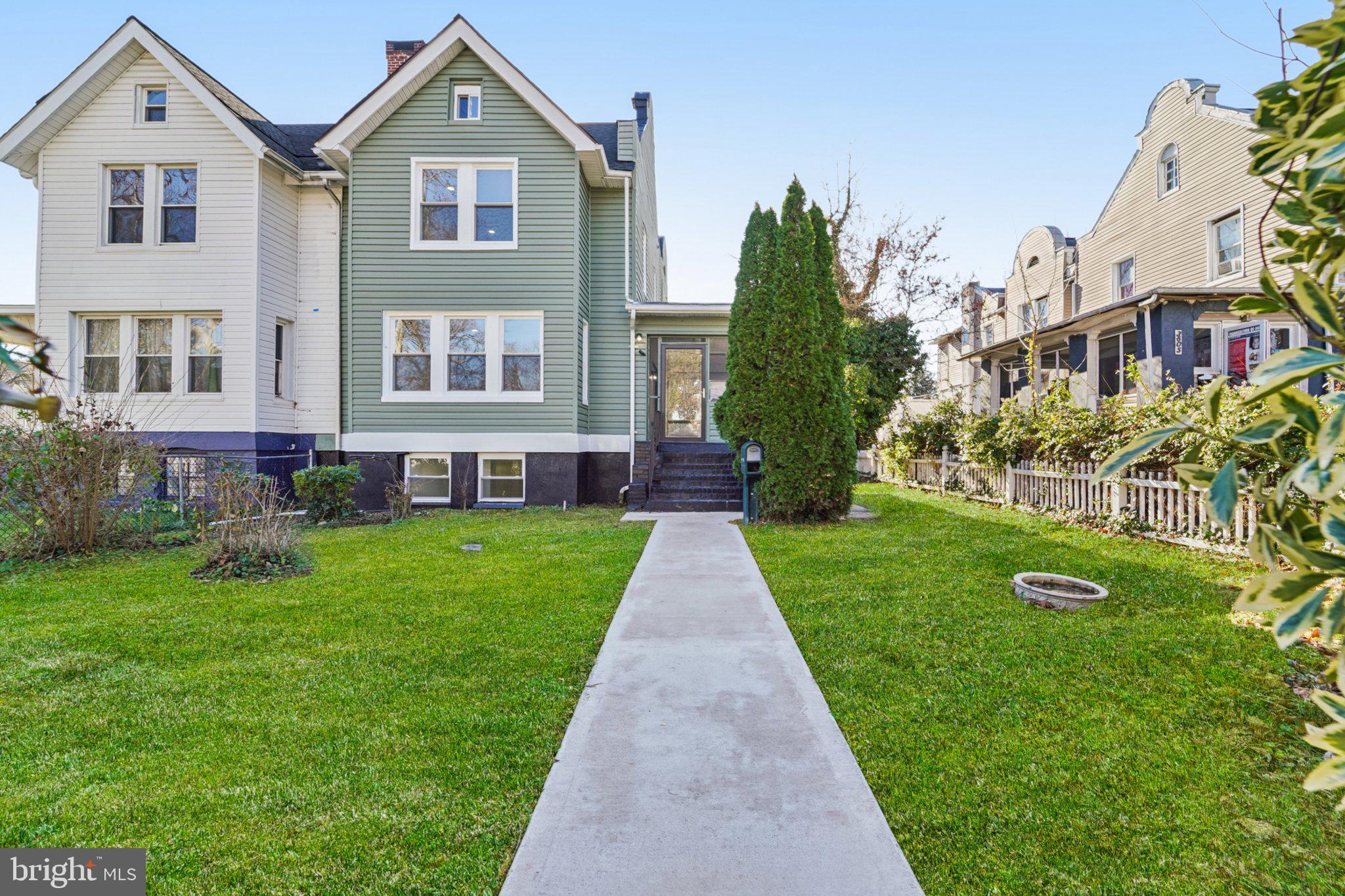 3603 Springdale Avenue Baltimore, MD 21216 - Photo 2 of 63 a front view of a house with a yard