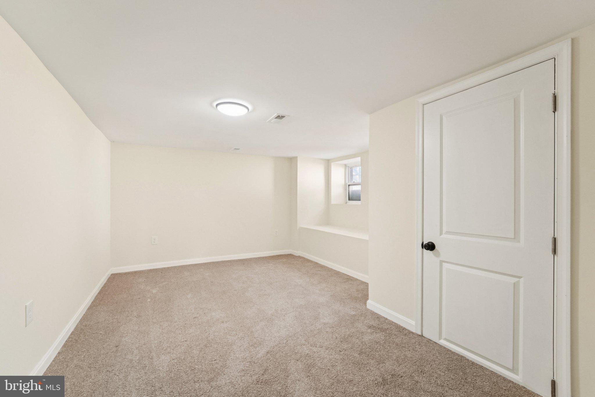3603 Springdale Avenue Baltimore, MD 21216 - Photo 25 of 63 a view of an empty room with a window