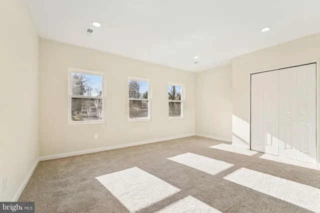 a view of a small space with wooden floor and a window