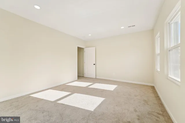 a view of a hallway with windows and chandelier