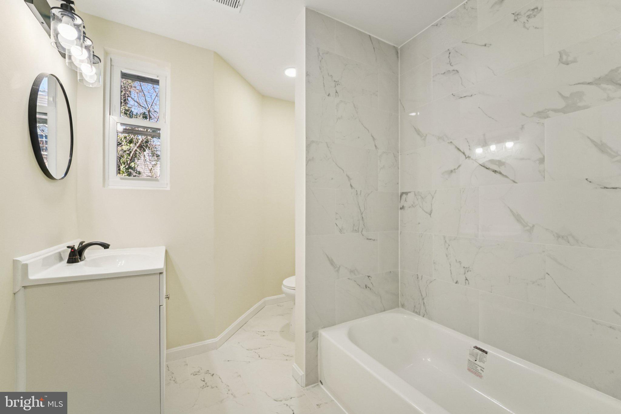 3603 Springdale Avenue Baltimore, MD 21216 - Photo 35 of 63 a bathroom with a sink a toilet and a bathtub