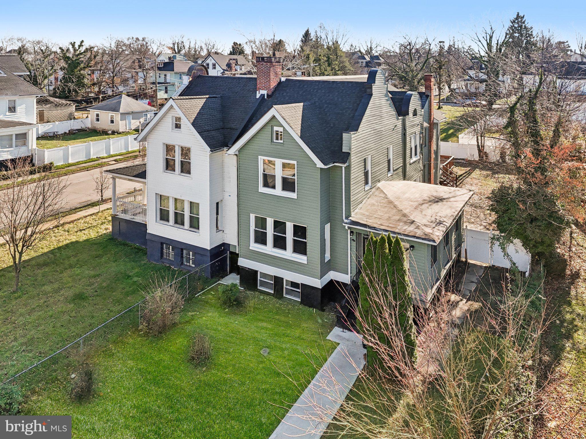 3603 Springdale Avenue Baltimore, MD 21216 - Photo 52 of 63 a front view of a house with a yard table and chairs