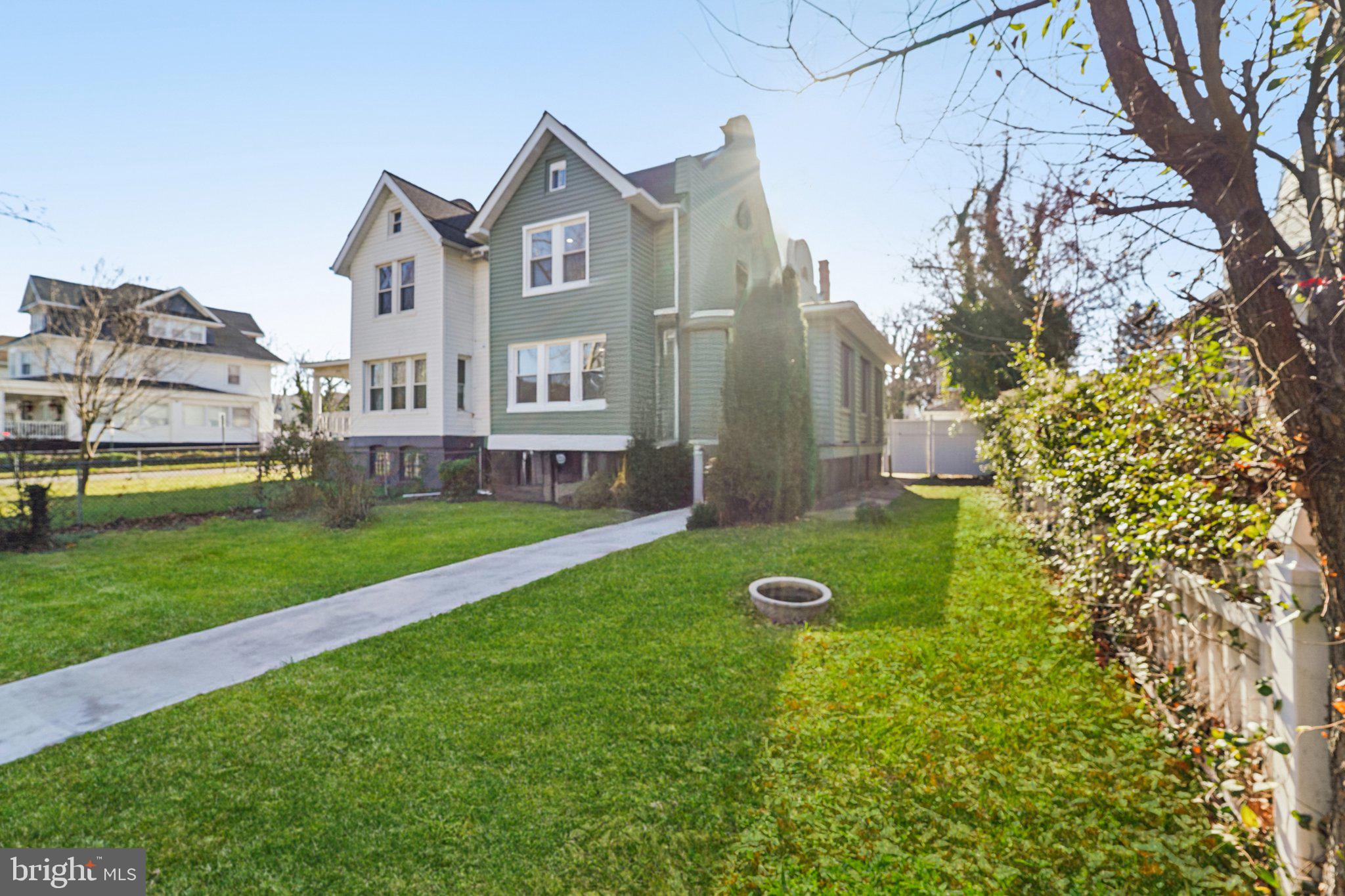 3603 Springdale Avenue Baltimore, MD 21216 - Photo 6 of 63 a view of a big house with a big yard and large trees