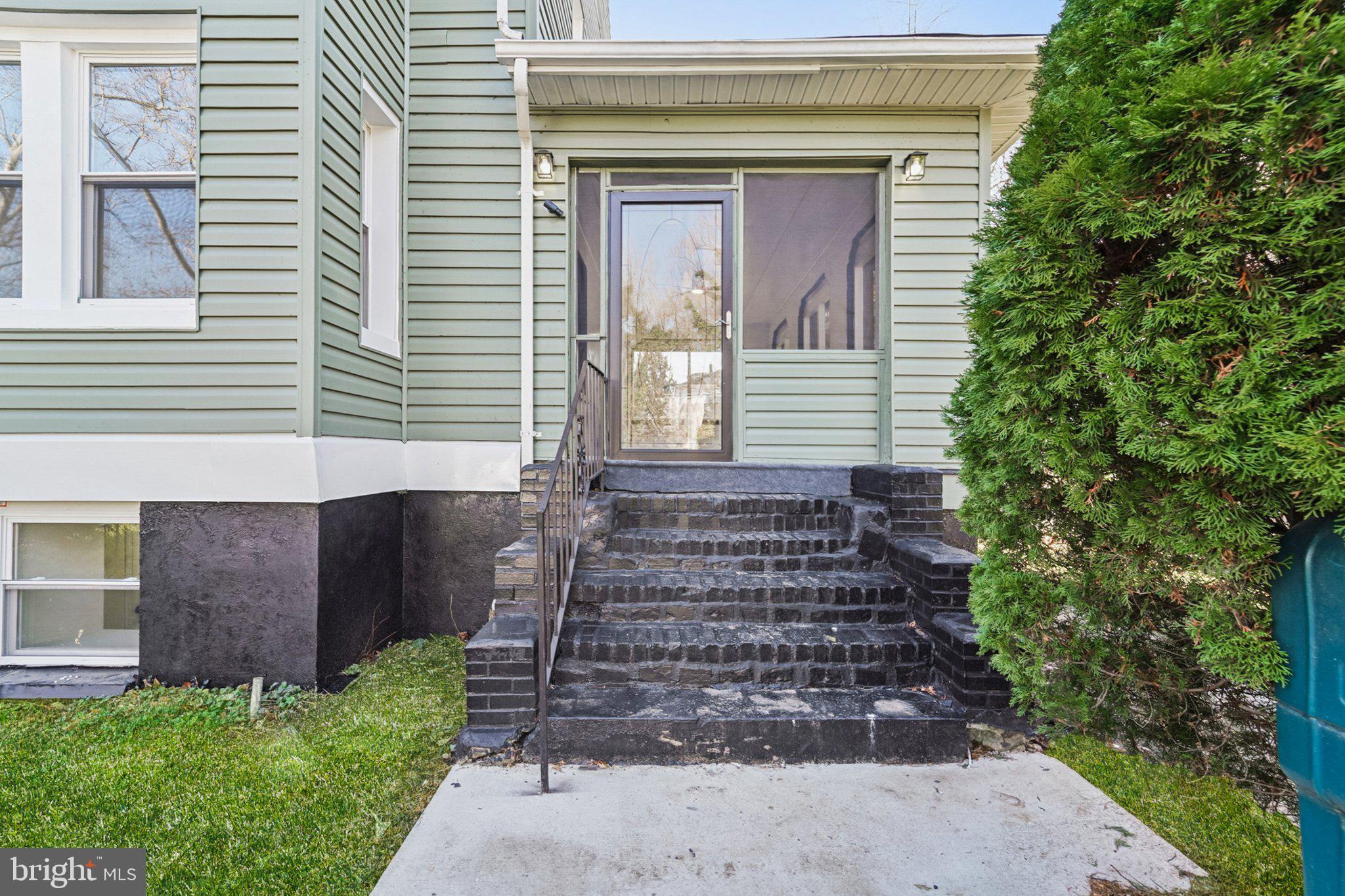 3603 Springdale Avenue Baltimore, MD 21216 - Photo 8 of 63 a front view of a house with a yard