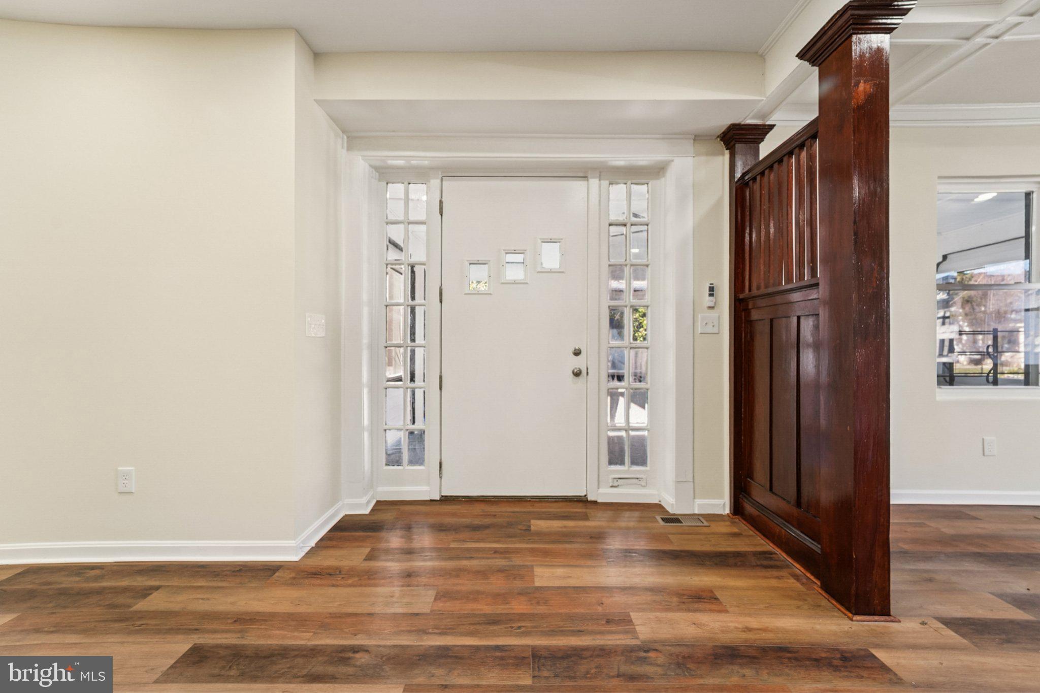 3603 Springdale Avenue Baltimore, MD 21216 - Photo 9 of 63 an empty room with wooden floor and a bathroom