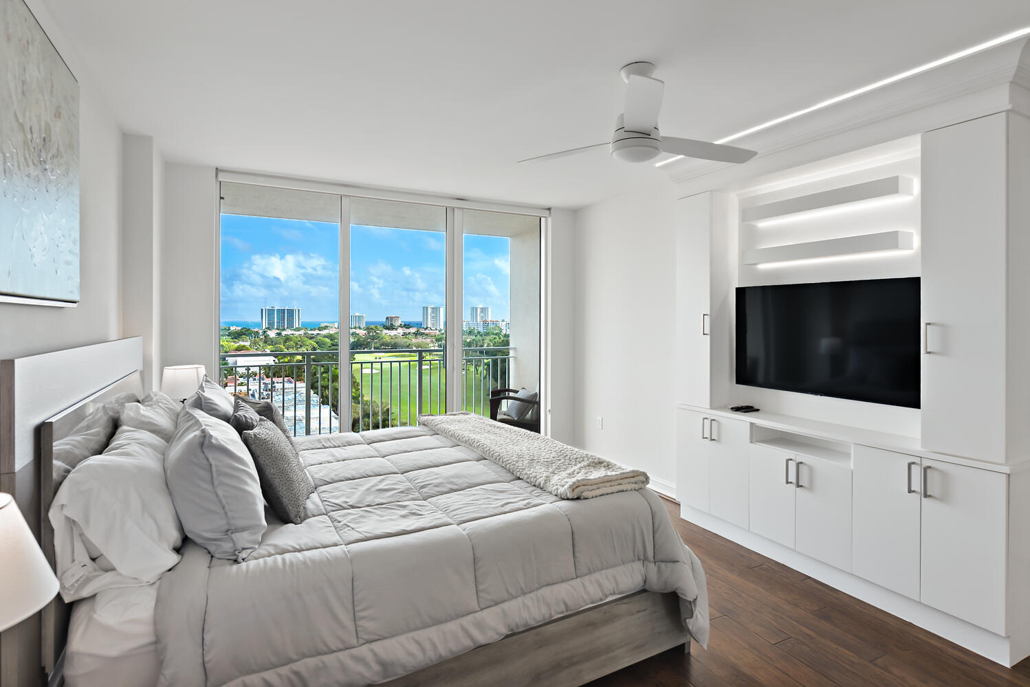 99 Southeast Mizner Boulevard, Unit PH 909 Boca Raton, FL 33432 - Photo 16 of 51 a bedroom with a bed and a flat screen tv