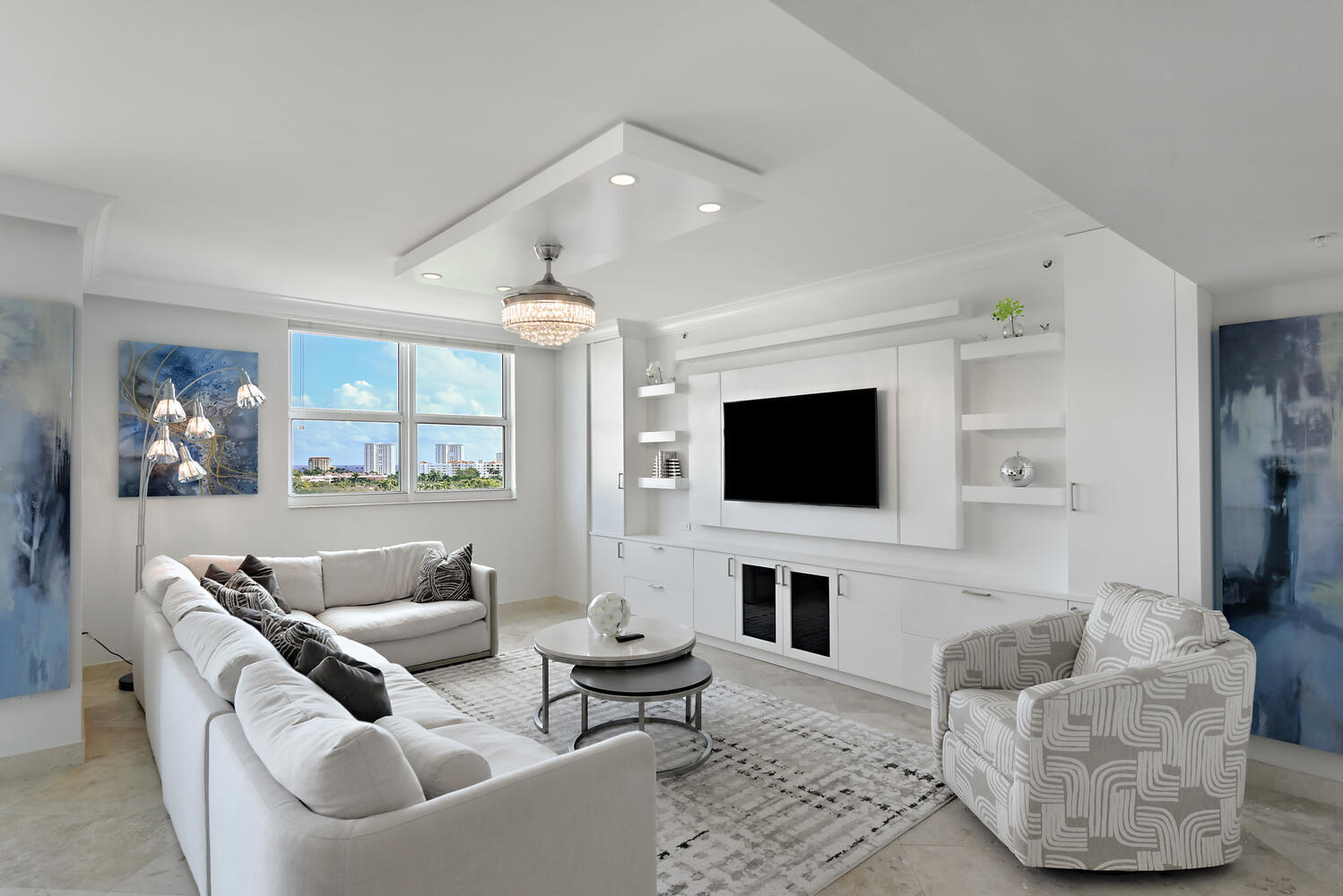 99 Southeast Mizner Boulevard, Unit PH 909 Boca Raton, FL 33432 - Photo 10 of 51 a living room with furniture and a flat screen tv