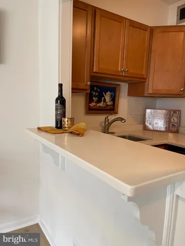 a kitchen with stainless steel appliances granite countertop a refrigerator stove top oven