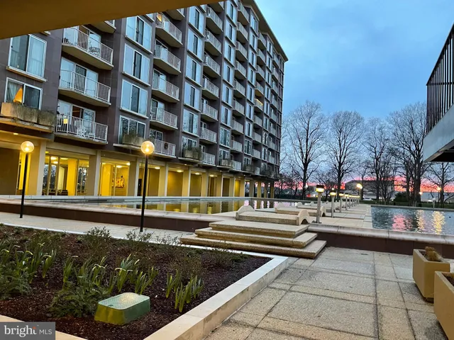 a view of a large building with a bench in front of building
