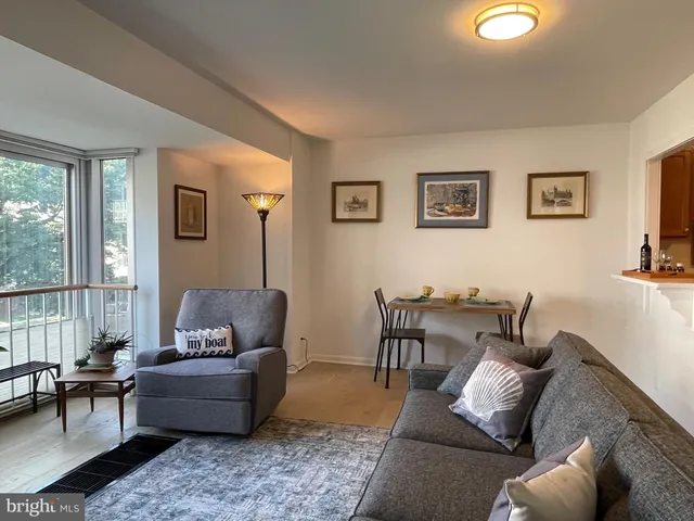 a living room with furniture and a floor to ceiling window