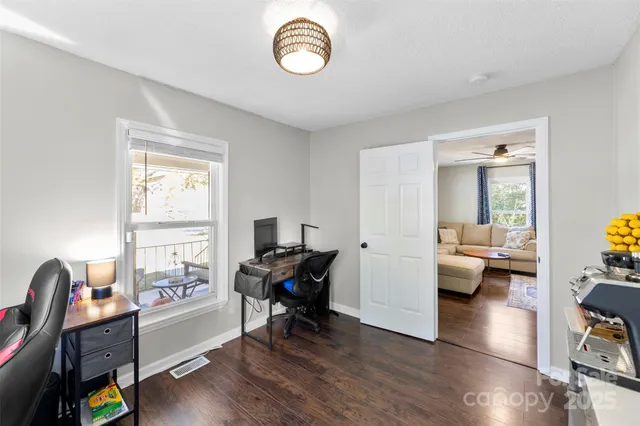 a view of a livingroom with workspace and a window
