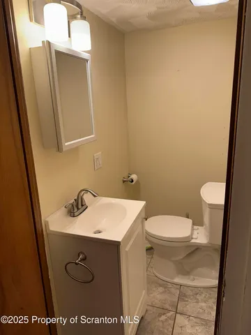 a bathroom with a sink toilet and mirror
