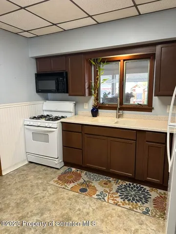 a kitchen with stainless steel appliances granite countertop a sink stove and microwave