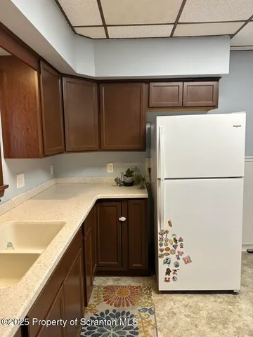 a kitchen with a refrigerator and a sink
