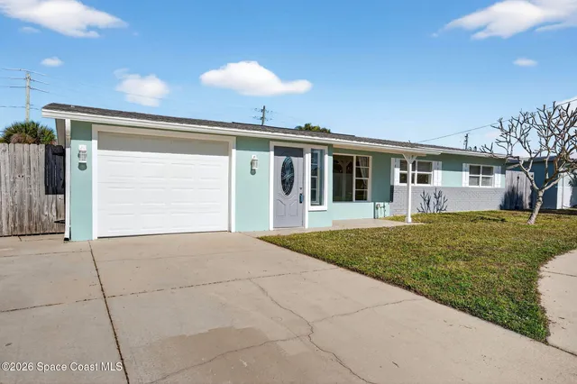 a view of a house with a backyard and porch